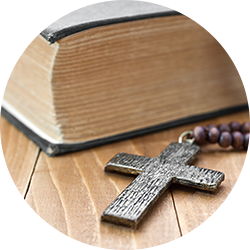 Wooden cross next to the Bible