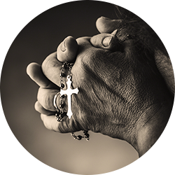 Person holding a cross pendant